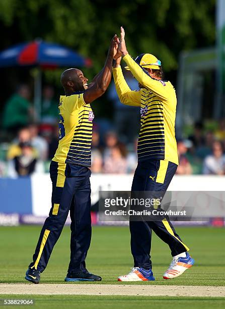 Tino Best of Hampshire celebrates taking the wicket of Joe Denly of Kent with team mate Sean Ervine during the NatWest T20 Blast match between Kent...