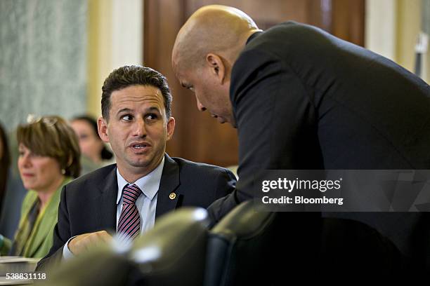 Senator Brian Schatz, a Democrat from Hawaii, left, talks to Senator Cory Booker, a Democrat from New Jersey, during a Senate Commerce, Science and...
