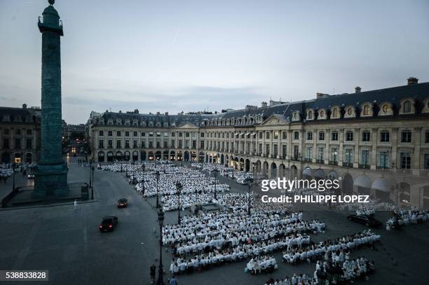 People dressed in white gather for the "Diner en Blanc" event at the place Vendome in Paris on June 8, 2016. The "Diner en Blanc" is a chic secret...