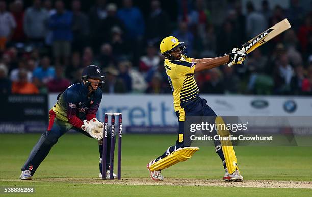 Shahid Afridi of Hampshire hits out while Sam Billings of Kent watches on during the NatWest T20 Blast match between Kent and Hampshire at The...