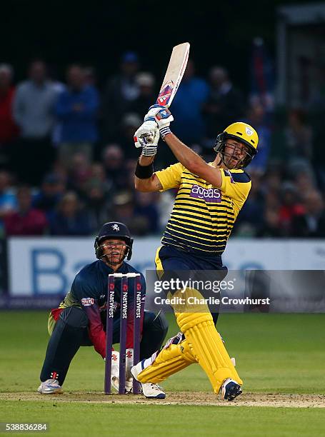 Sean Ervine of Hampshire hits out while Sam Billings of Kent looks on during the NatWest T20 Blast match between Kent and Hampshire at The Spitfire...