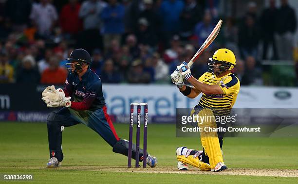 Sean Ervine of Hampshire hits out while Sam Billings of Kent looks on during the NatWest T20 Blast match between Kent and Hampshire at The Spitfire...