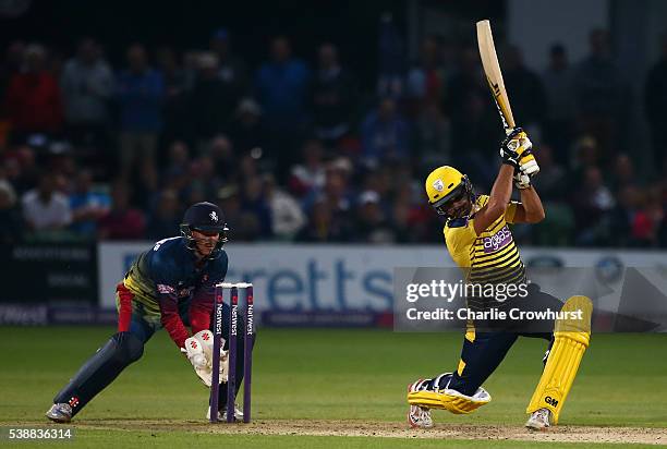 Shahid Afridi of Hampshire hits out while Sam Billings of Kent watches on during the NatWest T20 Blast match between Kent and Hampshire at The...