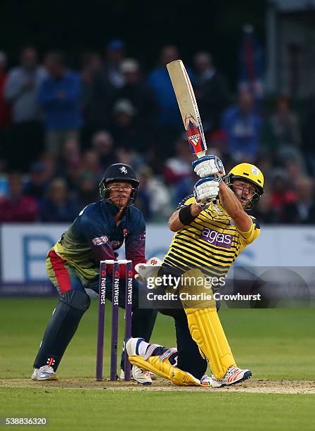 Sean Ervine of Hampshire hits out while Sam Billings of Kent looks on during the NatWest T20 Blast match between Kent and Hampshire at The Spitfire...