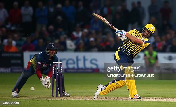 Sean Ervine of Hampshire hits out while Sam Billings of Kent looks on during the NatWest T20 Blast match between Kent and Hampshire at The Spitfire...