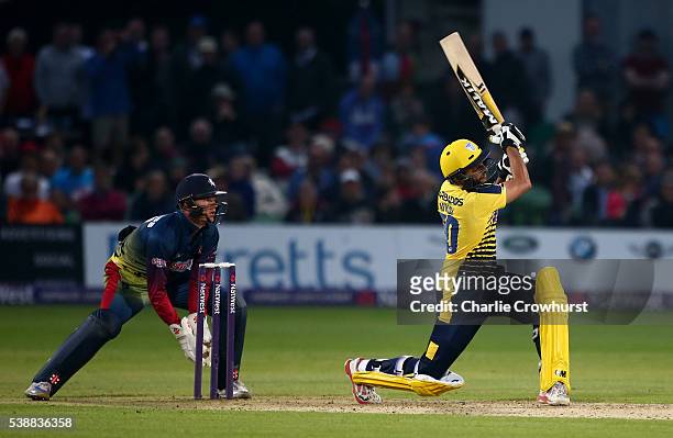 Shahid Afridi of Hampshire hits out while Sam Billings of Kent watches on during the NatWest T20 Blast match between Kent and Hampshire at The...