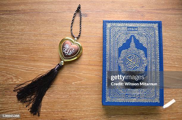 reading the holy quran(islamic book) in ramadan night. - table font view stock pictures, royalty-free photos & images