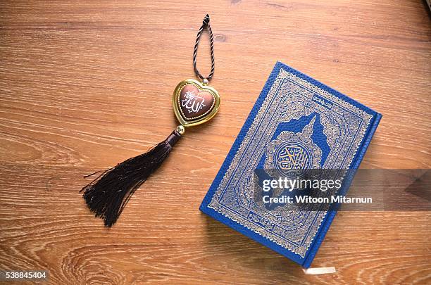 reading the holy quran(islamic book) in ramadan night. - table font view stock pictures, royalty-free photos & images