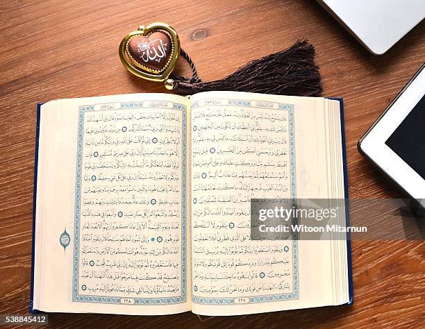 reading the holy quran(islamic book) in ramadan night. - table font view stock pictures, royalty-free photos & images