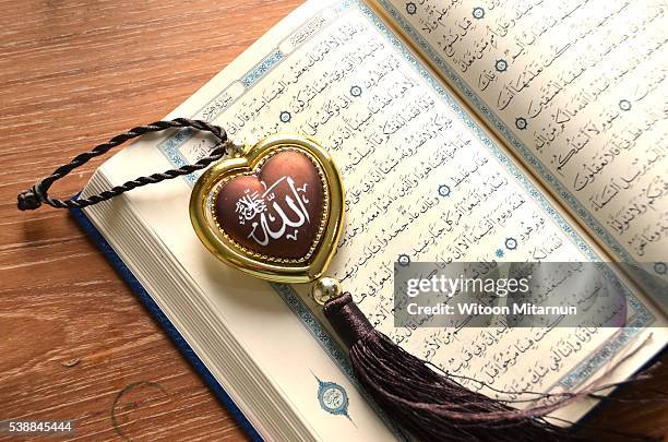 reading the holy quran(islamic book) in ramadan night. - table font view stock pictures, royalty-free photos & images