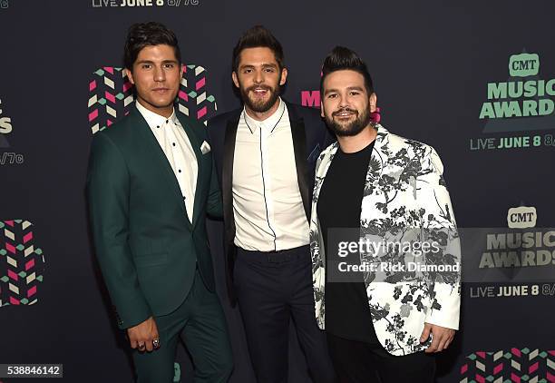 Dan Smyers and Shay Mooney pose with Thomas Rhett during the 2016 CMT Music awards at the Bridgestone Arena on June 8, 2016 in Nashville, Tennessee.