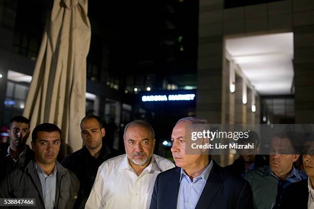 Israeli Prime Minister Benjamin Netanyahu and Defence Minister Avigdor Liberman speak to the press at the scene of a shooting outside Max Brenner...