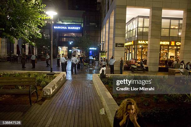 Israeli Policemen stand at the scene of a shooting outside Max Brenner restaurant in Sarona Market on June 8, 2016 in Tel Aviv, Israel. According to...