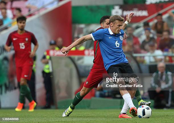Estonia's midfielder Aleksandr Dmitrijev with Portugal midfielder Joao Moutinho in action during the International Friendly match between Portugal...