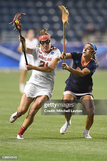 Taylor Cummings of the Maryland Terrapins runs with the ball by Kayla Treanor of the Syracuse Orange during the Semifinal NCCA Women's Lacrosse...