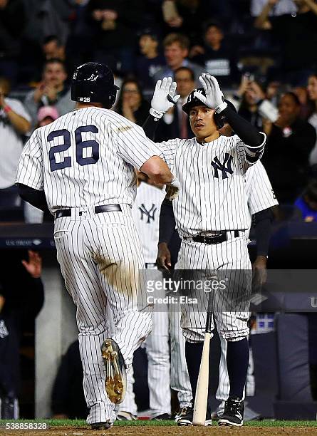 Chris Parmelee of the New York Yankees is congratated by teammate Ronald Torreyes after Parmelee hit a two run home run in the seventh inning against...