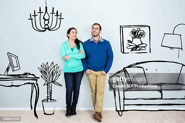 mid adult hispanic couple daydream in their new home - good move concept stockfoto's en -beelden