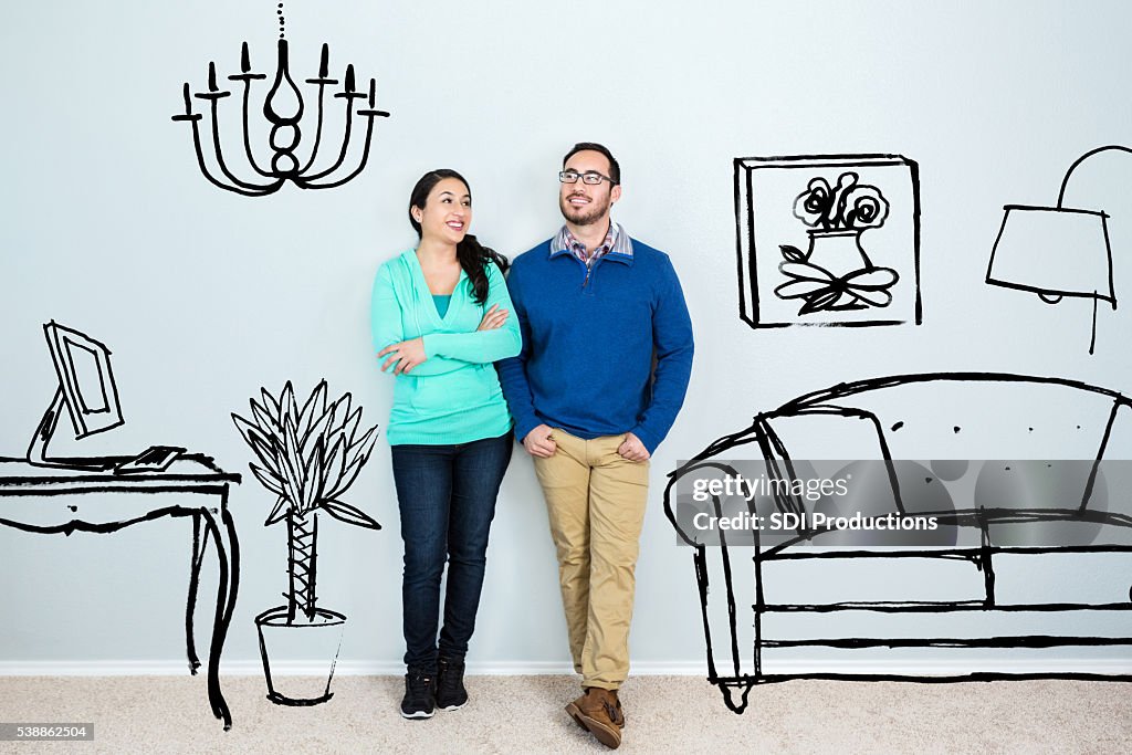 Mid adult Hispanic couple daydream in their new home