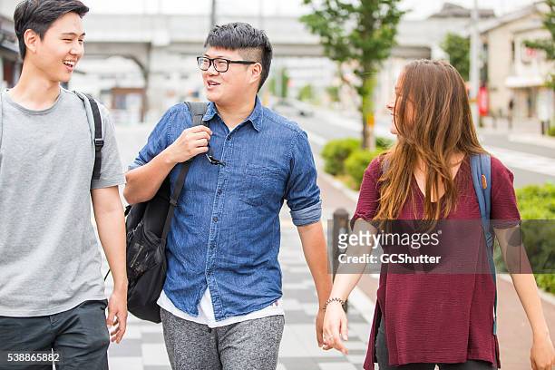 intresting conversation between group of friends while headed for college. - international student day stock pictures, royalty-free photos & images