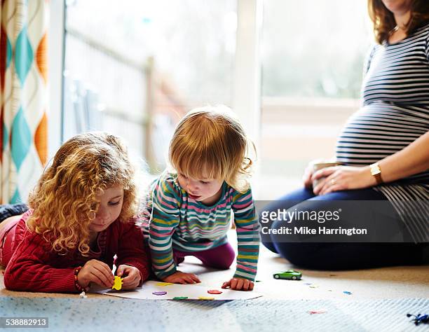 young sisters playing together - family with two children british stock pictures, royalty-free photos & images