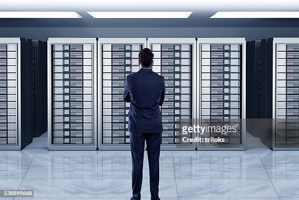 businessmen looking at server - data storage stockfoto's en -beelden