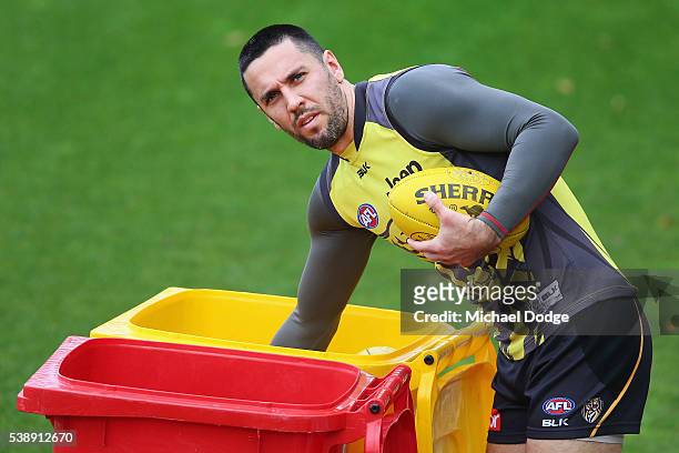 Troy Chaplin of the Tigers gathers balls during a Richmond Tigers AFL training session on June 9, 2016 in Melbourne, Australia.