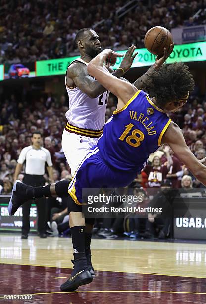 LeBron James of the Cleveland Cavaliers drives to the basket against Anderson Varejao of the Golden State Warriors during the second half in Game 3...