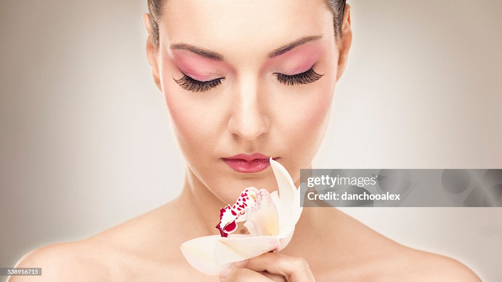 Beauty portrait of a woman holding a flower