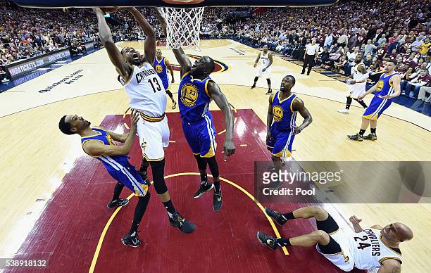 Tristan Thompson of the Cleveland Cavaliers shoots the ball against Shaun Livingston of the Golden State Warriors and Draymond Green in Game 3 of the...