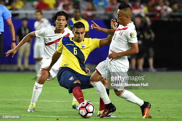 Christian Noboa of Ecuador battles for the ball with Christian Cueva of Peru during a group B match between Ecuador and Peru as part of Copa America...