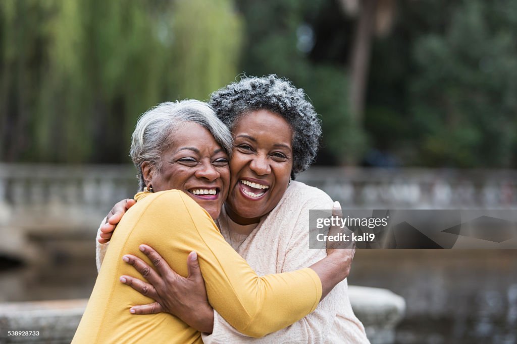 Senior black women embracing