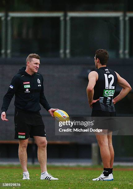 Magpies head coach Nathan Buckley speaks to Matthew Scharenberg during a Collingwood Magpies AFL media opportunity at the Glasshouse Theatre on June...