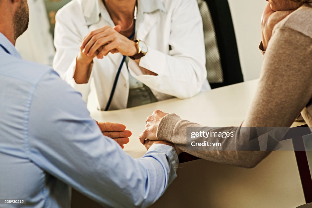 Worried Mature Couple with Female Doctor