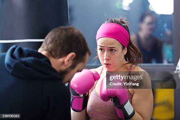 weight training and boxing exercise with coach in health club - kickboxing training stock pictures, royalty-free photos & images