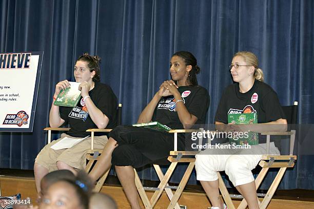 Janel McCarville, Tammy Sutton-Brown and Caity Matter of the Charlotte Sting read to children during the Sting's Read to Achieve event on August 6....