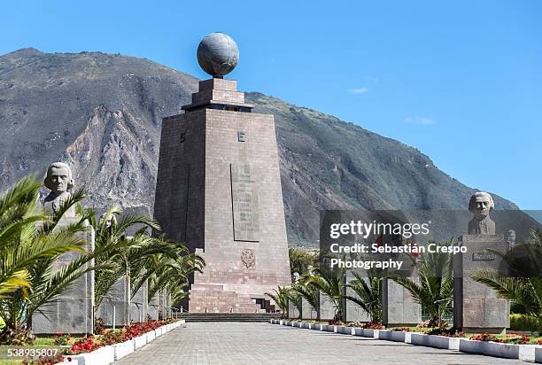 equator's monument in middle of the world city - äquator stock-fotos und bilder