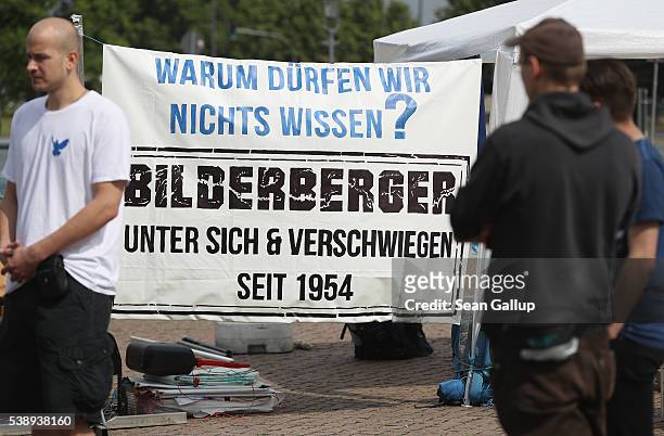 Peace activists with a banner that reads: "Why aren't we allowed to know? Bilderberger - amongst themselves and silent since 1954" maintain a vigil...