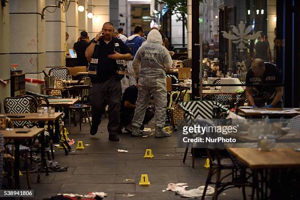Policemen are investigating the scene of a shooting attack in Sarona Market, Tel-Aviv on June 08'th, 2016. Four Israelis were killed and and 16...