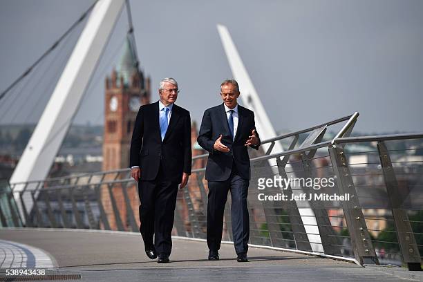 Sir John Major and Tony Blair speak as they walk across the Peace Bridge on June 9, 2016 in Derry, Northern Ireland. Former British Prime Ministers...