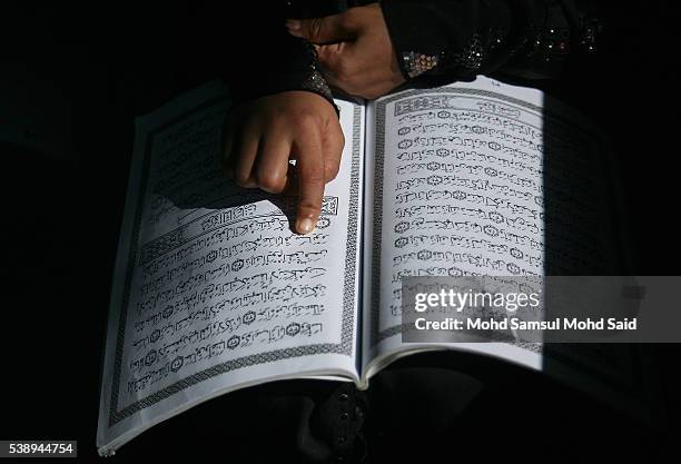 Rohingya Muslim reads the Koran inside the Madrasah during the holy month of Ramadan on June 9, 2016 in Klang outside Kuala Lumpur, Malaysia. Muslims...