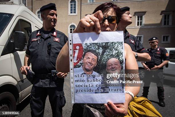 Protester showing a poster during protest against CONSOB in Rome. The "victims of saving banks' protest against the Commissione Nazionale per le...