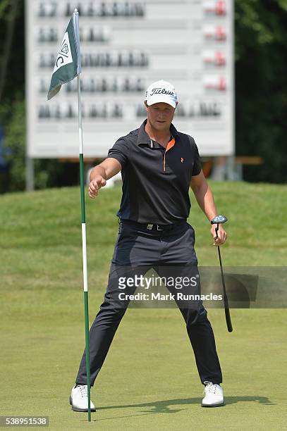 Bjorn Akesson of sweeden holds the pin, on hole nine during the first round of the Lyoness Open at Diamond Country Club on June 9, 2016 in...