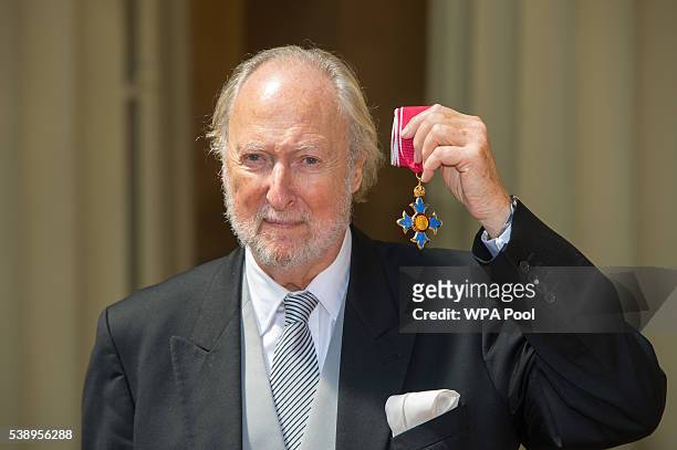 Literary agent Ed Victor poses after he received an CBE medal from the Prince of Wales for services to literature, at an investiture ceremony at...