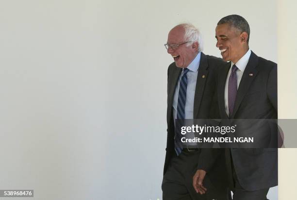 President Barack Obama walks with Democratic presidential candidate Bernie Sanders through the Colonnade for a meeting in the Oval Office on June 9,...