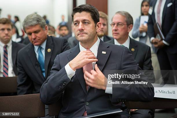 House Speaker Paul Ryan, adjusts his tie before a session on "Protecting the U.S. Homeland" at The Council on Foreign Relations on June 9 in...