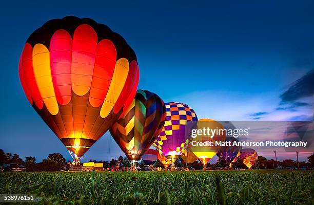 hot air balloon festival night glow - hot air balloon stock pictures, royalty-free photos & images