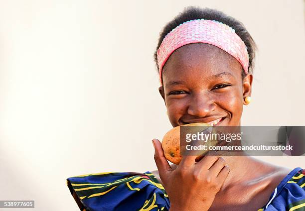 a teenage girl with a mango - commerceandculturestock stock pictures, royalty-free photos & images