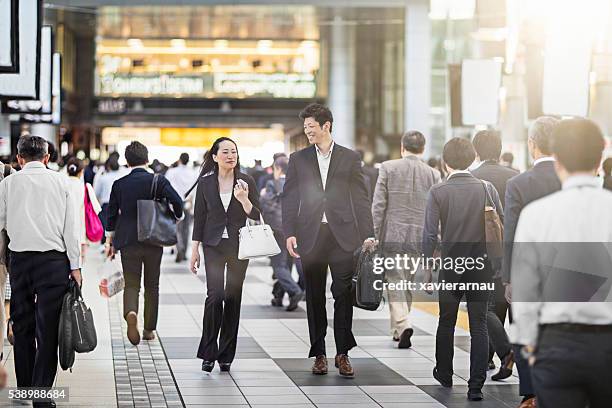 japanese business people commuting to work at the station - business man walking with a bag in asia bildbanksfoton och bilder