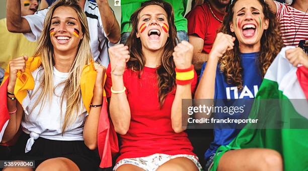 mixed national world supporter at the soccer stadium - female football fans stock pictures, royalty-free photos & images