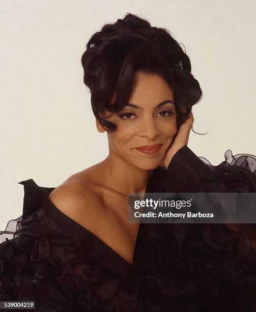 Portrait of American actress Jasmine Guy, dressed in black, as she poses against a white background, New York, 2000.